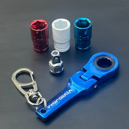 Set of small tools including a blue wrench and various sockets on a dark surface